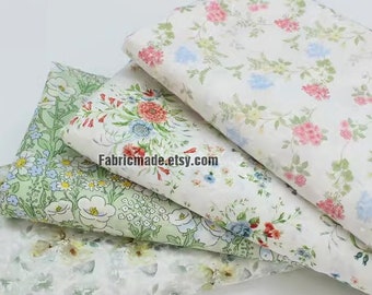 May include: Four pieces of floral patterned fabric in shades of green, white, and pink. The fabric is soft and delicate, perfect for crafting and sewing projects.