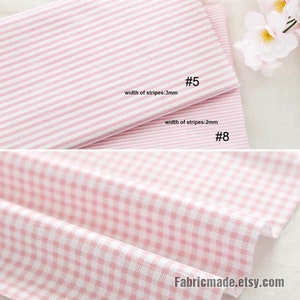 May include: Two pink and white striped fabrics with different stripe widths. The top fabric has stripes that are 3 mm wide and the bottom fabric has stripes that are 2 mm wide.  #5 and #8 are written on the fabrics.