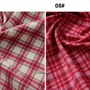 May include: Two fabric swatches with red and white plaid patterns. The swatches are 3 inches wide. The fabric on the left has a cream background, while the fabric on the right has a pink background.