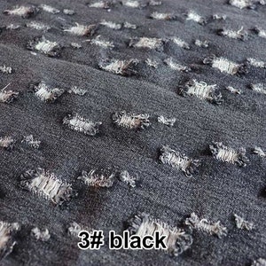 May include: Close-up of black denim fabric with a distressed, ripped look. The fabric has small, evenly spaced holes throughout, creating a unique and stylish texture. The text "3# black" is visible in the bottom right corner of the image.