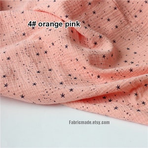 May include: Close-up of a peach-colored fabric with a star pattern. The fabric has a crinkled texture and the text "4# orange pink" is visible in the upper left corner. The Etsy shop name "Fabricmade.etsy.com" is in the lower right corner.