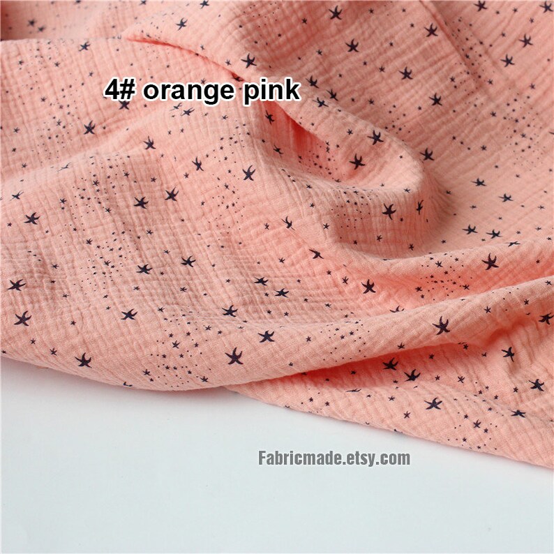 May include: Close-up of a peach-colored fabric with a star pattern. The fabric has a crinkled texture and the text "4# orange pink" is visible in the upper left corner. The Etsy shop name "Fabricmade.etsy.com" is in the lower right corner.