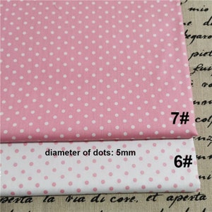 May include: Two pieces of pink and white polka dot fabric. The top piece is pink with white dots and the bottom piece is white with pink dots. The diameter of the dots is 5 mm. The fabric is labelled with the numbers 7# and 6#.