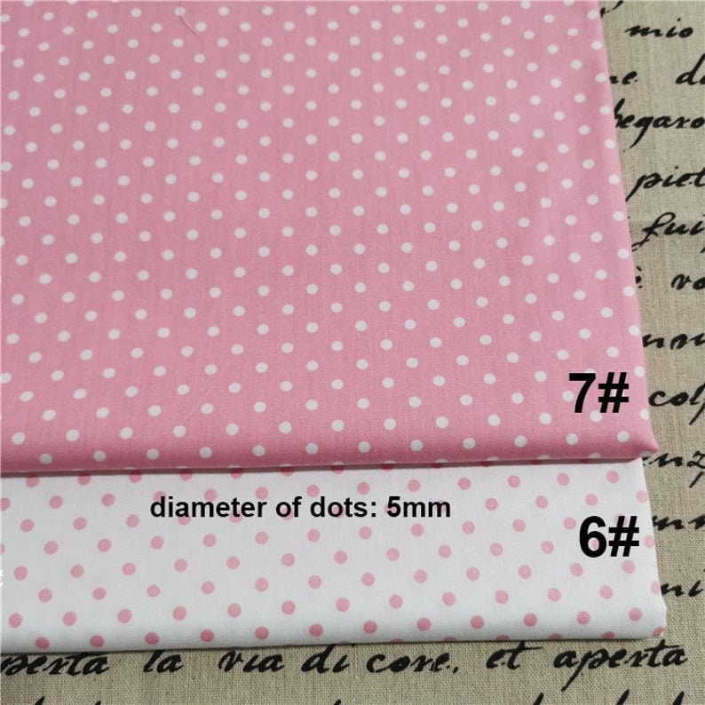 May include: Two pieces of pink and white polka dot fabric. The top piece is pink with white dots and the bottom piece is white with pink dots. The diameter of the dots is 5 mm. The fabric is labelled with the numbers 7# and 6#.