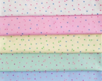 May include: Assortment of colorful fabric swatches. Each swatch features a repeating pattern of small dots and cherry illustrations. Colors include white, pink, yellow, mint green, and light blue. The dots are in coordinating colors.
