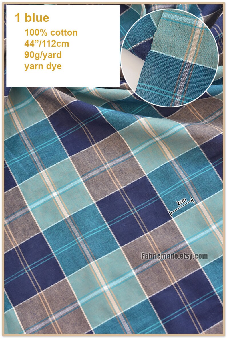 May include: A close-up of a blue, green, and brown plaid fabric. The fabric is 100% cotton and measures 44 inches by 112 centimeters. The fabric is 90 grams per yard and is yarn dyed.
