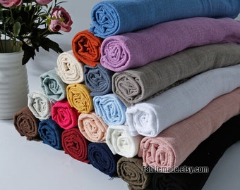 May include: A stack of 20 rolled fabric swatches in various colors, including blue, purple, brown, white, pink, red, yellow, and black. The fabric is a soft, linen-like material. The text "Fabricmade.etsy.com" is visible at the bottom of the image.