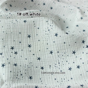 May include: Off-white fabric with a textured, crinkled surface. The fabric is patterned with small, dark blue star shapes and tiny dots. The text "1# off white" is visible in the upper left corner. The Etsy shop name is visible at the bottom.