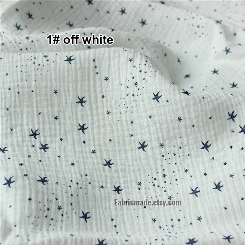 May include: Off-white fabric with a textured, crinkled surface. The fabric is patterned with small, dark blue star shapes and tiny dots. The text "1# off white" is visible in the upper left corner. The Etsy shop name is visible at the bottom.