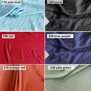 May include: Six fabric swatches with a scale pattern. The swatches are in the following colors: pale blue, black, red, blue purple, orange red, and pale green.