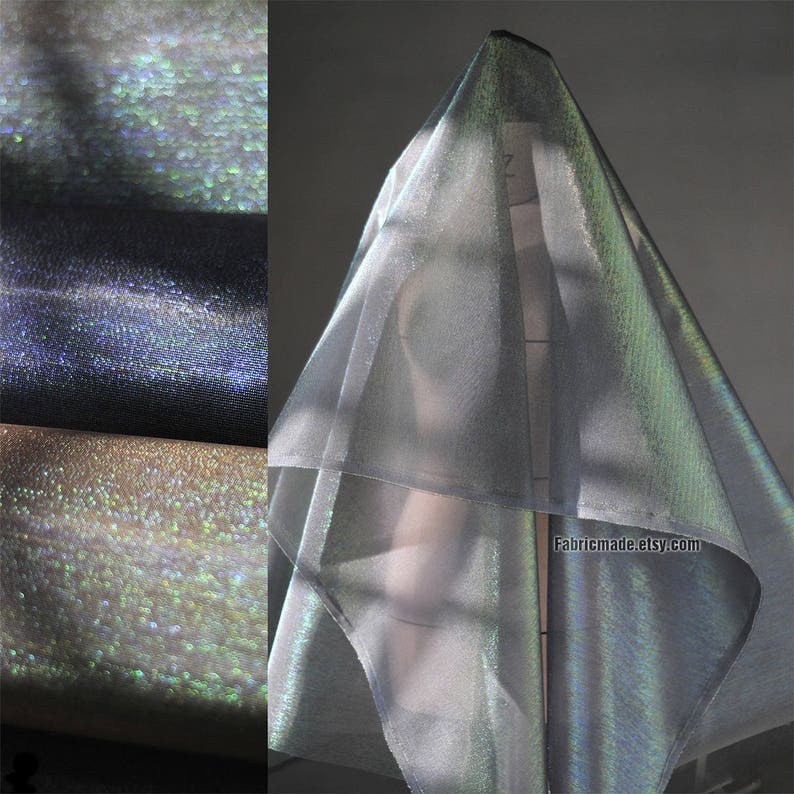 May include: Iridescent fabric in shades of silver, blue, and gold. The fabric is draped over a form, showcasing its shimmering qualities. The image also shows rolls of the fabric, highlighting its texture and color variations. The website address fabricmade.etsy.com is visible.