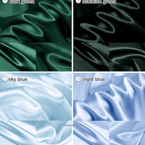 May include: Four swatches of fabric in different colors: dark green, blackish green, sky blue, and light blue. The fabric is a smooth, silky material.