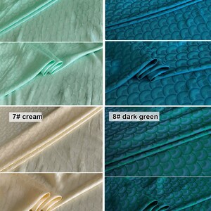 May include: Four fabric swatches with a repeating pattern of stylized fans. The swatches are aqua green, peacock blue, cream, and dark green.