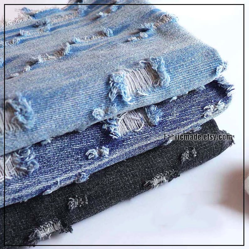 May include: Three layers of distressed denim fabric. The top layer is light blue, the middle layer is dark blue, and the bottom layer is black.