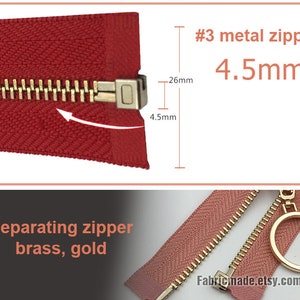 May include: A close-up of a red zipper with a gold metal slider. The zipper is #3 size and 4.5mm wide. The zipper is labeled "Separating zipper brass, gold".