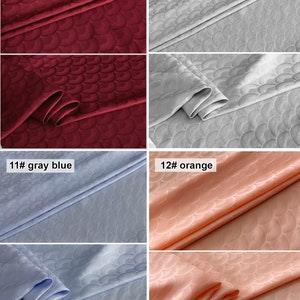 May include: Four fabric swatches with a repeating pattern of overlapping semi-circles. The swatches are burgundy, silver gray, light blue, and peach.