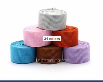 May include: A stack of six different colored 1 inch wide elastic bands. The colors are light grey, pink, orange, brown, light blue, and purple. The text "31 colors" and "Fabricmade.etsy.com" are visible on the image.  1 inch/25mm Width Elastic Band
