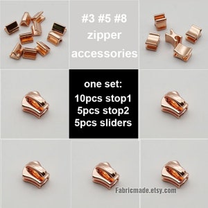 Puede incluir: Un conjunto de accesorios para cremalleras de color dorado, que incluye 10 piezas stop1, 5 piezas stop2 y 5 deslizadores. El texto "#3 #5 #8 zipper accessories" y "one set: 10pcs stop1 5pcs stop2 5pcs sliders" es visible en la imagen.