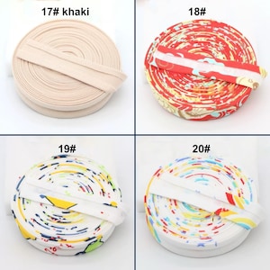 May include: Four spools of fabric trim in various colors and patterns. One spool is khaki with the text "17# khaki". The others are red, white, and multi-colored with the numbers "18#", "19#", and "20#".
