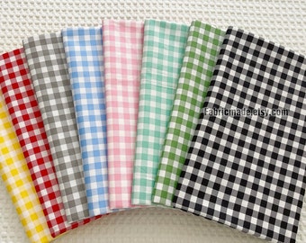 May include: A collection of eight fabric swatches in various gingham patterns. The swatches are arranged in a fan shape, with the black and white gingham swatch at the bottom. The swatches are all 1/2 inch gingham.