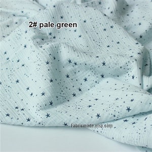 May include: Pale green fabric with a pattern of dark blue star shapes. The fabric has a crinkled texture and the text "2# pale green" is visible. The Etsy shop name "Fabricmade.etsy.com" is also visible.