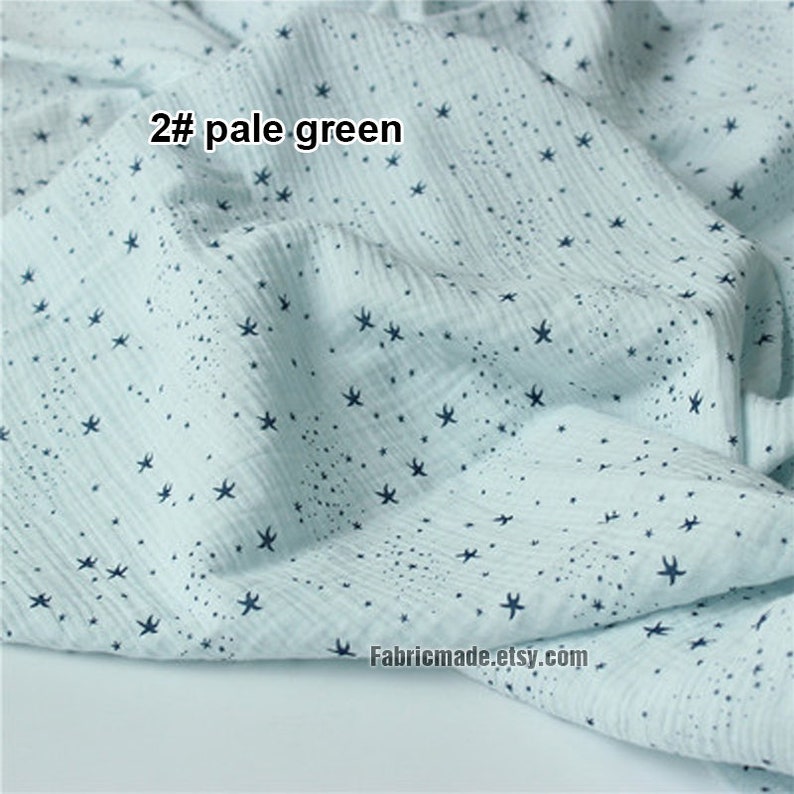 May include: Pale green fabric with a pattern of dark blue star shapes. The fabric has a crinkled texture and the text "2# pale green" is visible. The Etsy shop name "Fabricmade.etsy.com" is also visible.