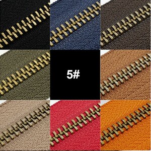 May include: A close-up of a variety of zipper tapes in different colors and sizes. The zipper tapes are arranged in a grid pattern, with each row representing a different size: 3#, 5#, and 8#. The zipper teeth are gold-colored.