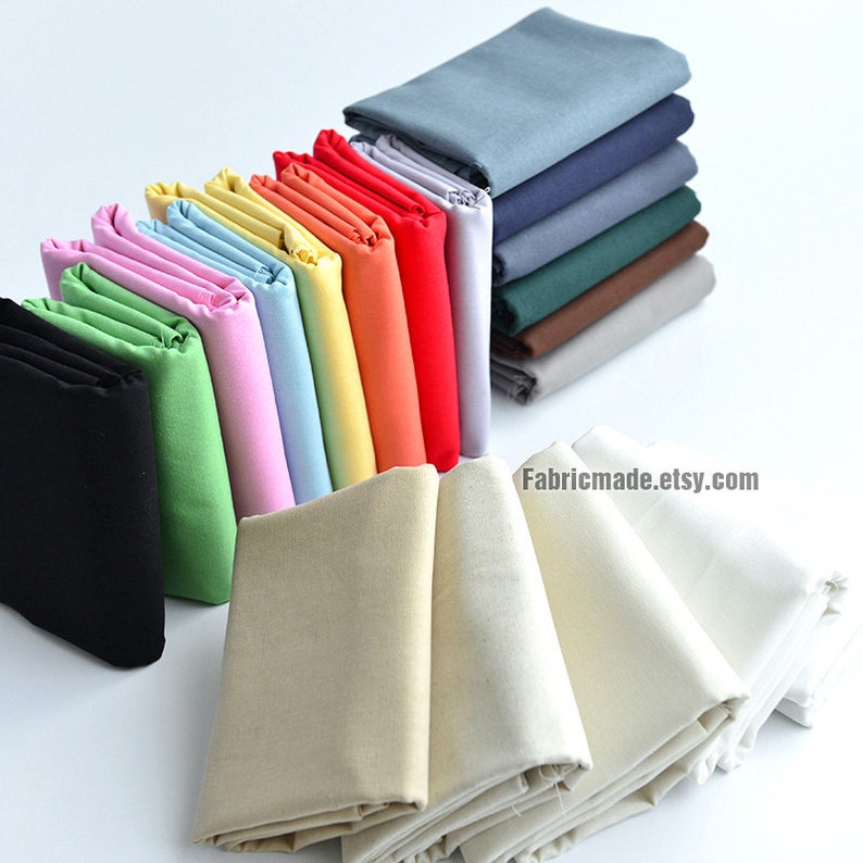 May include: A variety of fabric swatches in different colors, including black, green, pink, light blue, yellow, orange, red, and beige. The swatches are folded and arranged in a row. The text "Fabricmade.etsy.com" is visible in the lower right corner of the image.