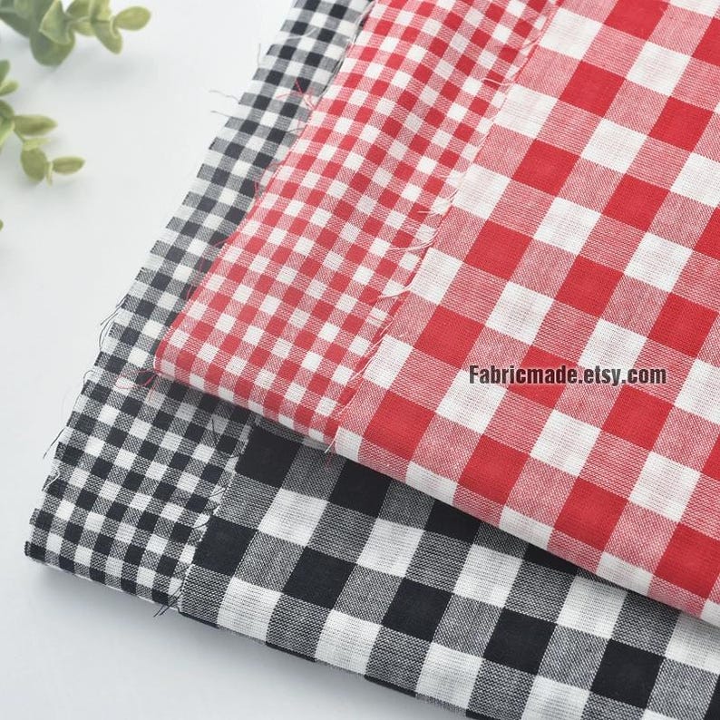 May include: Close-up of three fabric swatches with a classic gingham pattern. The fabrics are in red and white, and black and white. The website address Fabricmade.etsy.com is visible on the red and white fabric.