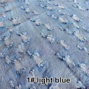 May include: Light blue denim fabric with a distressed look. The fabric has many small holes and tears throughout. The text "1# light blue" is visible in the bottom right corner of the image.