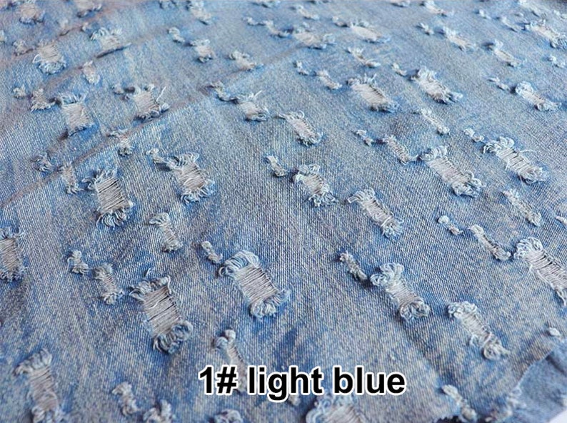 May include: Light blue denim fabric with a distressed look. The fabric has many small holes and tears throughout. The text "1# light blue" is visible in the bottom right corner of the image.