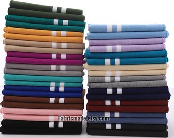 May include: A stack of 20 different colored knit fabric with white stripes. The fabric is folded and stacked in two columns. The fabric is available in colors such as green, blue, purple, pink, brown, and black. The text "Fabricmade.etsy.com" is visible at the bottom of the image.