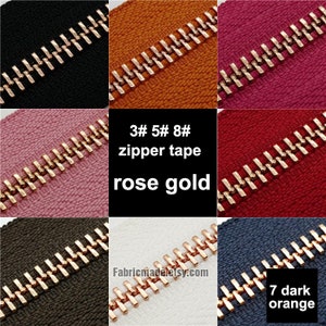 May include: Assortment of zipper tapes in various colors with rose gold zipper teeth. The zipper tapes are 3#, 5#, 8# and 7# dark orange. The text "3# 5# 8# zipper tape rose gold" is displayed in the center of the image.