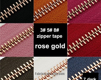 May include: Assortment of zipper tapes in various colors with rose gold zipper teeth. The zipper tapes are 3#, 5#, 8# and 7# dark orange. The text "3# 5# 8# zipper tape rose gold" is displayed in the center of the image.