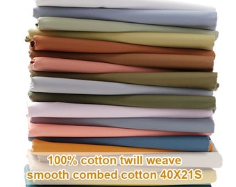 May include: A stack of 18 different colored fabric swatches. The fabric is 100% cotton twill weave, smooth combed cotton 40x21s.