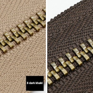 May include: Two zipper tapes with brass teeth. The tape on the left is a dark khaki color. The tape on the right is a dark brown color. The text below the tapes reads "8 dark khaki" and "9 coffee".
