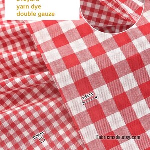 May include: Red and white checkered double gauze fabric. The fabric is 59 inches wide and made of 100% cotton. The image includes text that says "1 red", "100% cotton", "59"/145cm", "215yard", "yarn dye", and "double gauze".