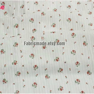 May include: White fabric with a small red rose print and thin vertical stripes. The fabric is folded in half and the text "Fabricmade.etsy.com" is printed on the fabric.