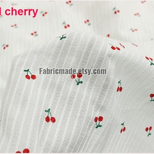 May include: White fabric with a repeating pattern of red cherries. The fabric has a subtle striped texture. The text "1# red cherry" is visible in the top left corner.