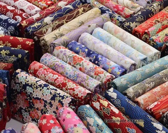 May include: A collection of colorful fabric rolls with various Japanese-inspired patterns, including floral, geometric, and animal designs. The fabric is arranged in rows, with the ends of the rolls visible. The fabric is likely intended for quilting, sewing, or crafting projects.