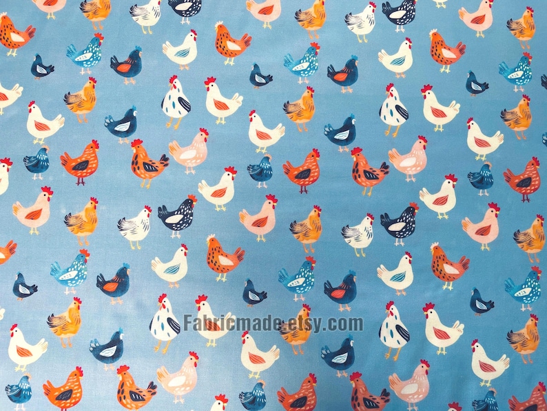 May include: A light blue fabric featuring a repeating pattern of chickens in various colors including white, orange, and dark blue. The chickens are depicted in different poses across the surface. The text Fabricmade.etsy.com is visible.