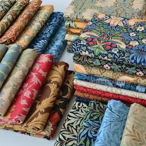 May include: A collection of fabric swatches featuring various floral and botanical patterns in a variety of colours, including red, blue, green, and brown. The fabric is arranged in stacks and is likely intended for quilting or other craft projects.