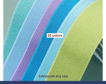 May include: A close-up of a variety of colours of 1.2" wide elastic band. The colours include light green, light blue, lavender, and turquoise. The text "35 colours" and "Fabricmade.etsy.com" are visible in the image. The text "1.2"/3cm Width Elastic Band" is visible at the bottom of the image.