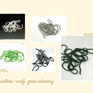 May include: A collection of five coiled cords in white, light gray, bright green, black, and dark forest green. The cords are displayed in individual square frames with the text Gruntone-weiß, grau schwarz printed at the bottom of the image.