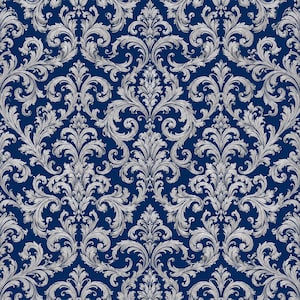 May include: A deep navy blue wallpaper featuring a repeating damask pattern in a light silver gray. The design consists of intricate, symmetrical scrolling acanthus leaves and floral motifs that create a dense, ornate, and continuous texture.