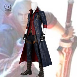 Op de afbeelding: Een lange marineblauwe jas met een rode binnenvoering, gedragen over een rood vest en een donkere broek. De outfit bevat een bruine holsterriem, zwarte vingerloze handschoenen en donkerbruine laarzen op een witte etalagepop.