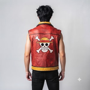 May include: A sleeveless red leather vest featuring a yellow collar and bottom hem. The back displays a large white skull and crossbones graphic wearing a yellow straw hat with a red band, inspired by the One Piece anime series emblem.