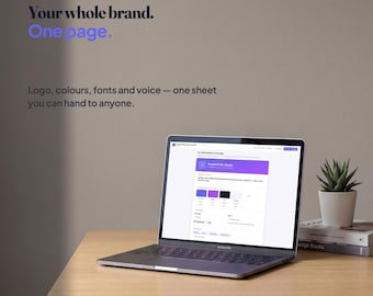 May include: A silver laptop displaying a Plotline brand identity page on its screen. The text on the wall reads: Plotline, Your whole brand. One page. Logo, colours, fonts and voice — one sheet you can hand to anyone. A small potted succulent sits nearby.
