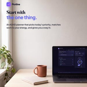 May include: A laptop displaying a dark-themed ADHD planner interface, a terracotta-colored mug, and a closed notebook on a light wood desk. Text on the wall reads: Plotline, Start with the one thing. An ADHD planner that picks today's priority.