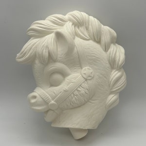May include: White ceramic horse head figurine with a star on the bridle. The horse has a detailed mane and a playful expression.